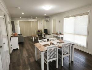 a living room with a table and chairs and a couch at Convenience Plus in Warwick