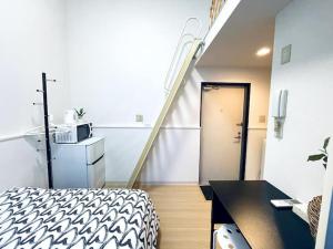 a room with a staircase and a bed and a table at A02 Shinjuku center-4mins to room 10min to Kabukicho-新宿商圈Loftoom in Tokyo