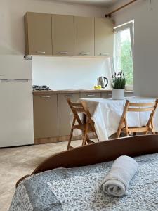a kitchen with a table and a white refrigerator at Apartments by the sea Lumbarda, Korcula - 4442 in Lumbarda +29 photos