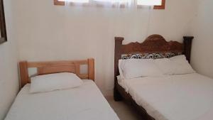 Postel nebo postele na pokoji v ubytování HOSTAL LA BOQUILLA