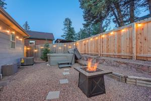a backyard with a fire pit and a fence at Hot Tub - Game Room - Wood Fireplace in Chipita Park