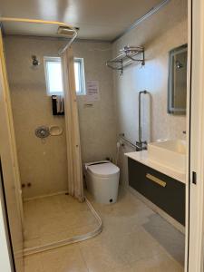 a bathroom with a shower and a toilet and a sink at 皇后超級管家 in Hong Kong