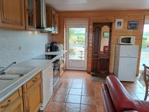 a kitchen with a sink and a refrigerator at Stone House in Cleder near Sandy Beach in Cléder