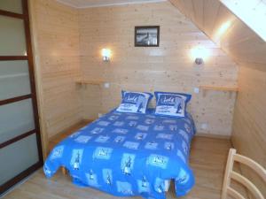 a bedroom with a bed in a wooden room at Stone House in Cleder near Les Amiets Beach in Cléder
