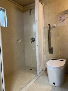 a bathroom with a toilet and a shower at 皇后超級管家 in Hong Kong