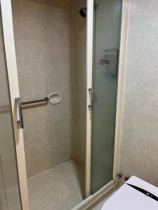 a bathroom with a glass shower with a toilet at 皇后超級管家 in Hong Kong