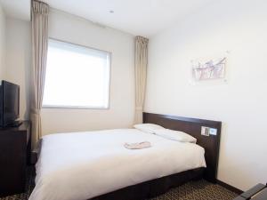 Postel nebo postele na pokoji v ubytování Hearton Hotel Higashi-Shinagawa