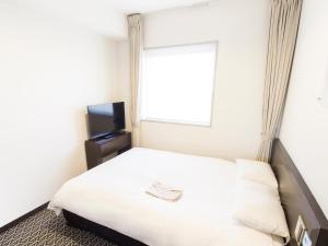 Postel nebo postele na pokoji v ubytování Hearton Hotel Higashi-Shinagawa