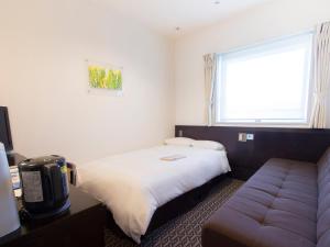 Postel nebo postele na pokoji v ubytování Hearton Hotel Higashi-Shinagawa