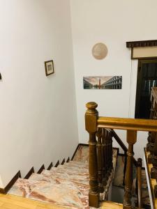 a staircase in a house with a wooden railing at Venice Villa House in Mestre