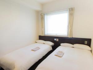 Postel nebo postele na pokoji v ubytování Hearton Hotel Higashi-Shinagawa
