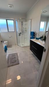 a large bathroom with a shower and a sink at Downtown Whakatane in Whakatane +10 photos