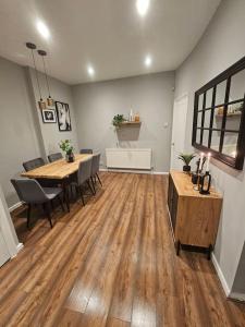 a living room with a table and chairs and a dining room at Hillsome Hosting Wigan in Pemberton