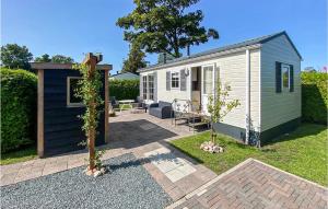 a tiny house in a garden with a patio at Lovely Home In Tzummarum With Wifi in Tzummarum