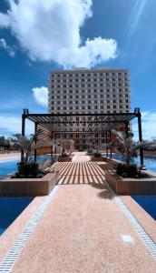 a hotel with a large building in the background at RF Condotel in Lapu Lapu City