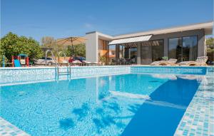 a swimming pool in front of a house at Gorgeous Home In Katuni With Wifi in Katuni +50 photos