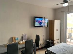 a living room with a tv on the wall at RF Condotel in Lapu Lapu City