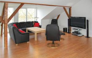 a living room with a couch and a television at Seven-Bedroom Holiday Home In Bredebro in Bredebro