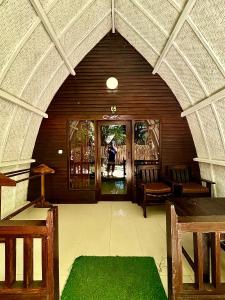 an archway in a building with a person walking through the door at Alibaba Bungalows in Gili Air