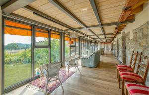 a room with chairs and tables and windows at Discover Oltrepo in Fortunago
