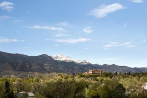 a view of a mountain range with a house at Holiday Inn Express & Suites Colorado Springs Central by IHG in Colorado Springs