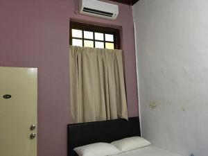 Postel nebo postele na pokoji v ubytování Old Penang Hotel - Trang Road