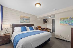 a bedroom with a large bed with a blue blanket at Lost Trail in Lava Hot Springs