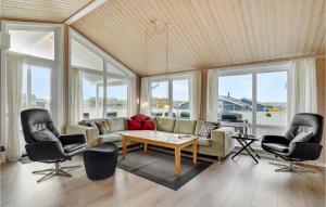 a living room with a couch and two chairs and a table at Holiday Home Bjerregårdsvej Hvide Sande Denm in Bjerregård