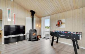 a living room with a pool table and a fireplace at Holiday Home Bjerregårdsvej Hvide Sande Denm in Bjerregård