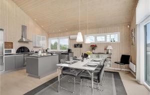 a kitchen with a table and chairs in a room at Holiday Home Jordbærvej Tarm Iv in Hemmet +31 photos