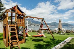 a group of children playing on a playground at All'oro in Njivice