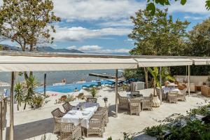 a patio with a table and chairs and a pool at All'oro in Njivice