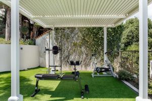 an outdoor gym with exercise equipment on the grass at All'oro in Njivice