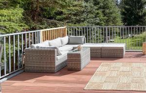 a wicker couch and a table on a patio at One-Bedroom Holiday Home In Biskupiec in Biskupiec