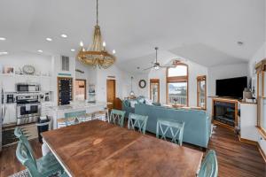 a kitchen and dining room with a table and chairs at Beautiful OBX Home w, Pristine Views cottage in Corolla