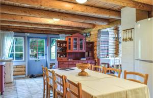 a kitchen and dining room with a table and chairs at 5 Bedroom Gorgeous Home In Vegårshei in Vegårshei