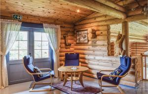 a room with a table and chairs in a log cabin at 5 Bedroom Gorgeous Home In Vegårshei in Vegårshei