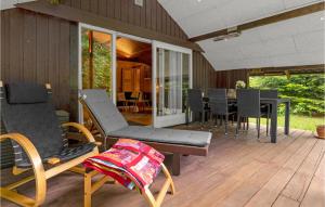 a patio with chairs and a table on a deck at 4 Bedroom Beautiful Home In Toftlund in Toftlund +21 photos