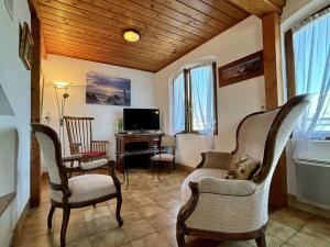 a living room with chairs and a table and a tv at Maison 4 pièces à Oléron avec WIFI et jardin proche plage - FR-1-246A-322 in Saint-Pierre-dʼOléron