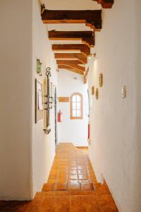 an empty hallway with a tile floor and wooden ceilings at Casa Aimée in Mexico City