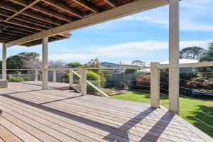 a large wooden deck in a yard at Sommerhuset by Ready Set Stay in Cowes
