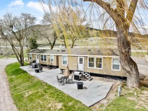 a house with a patio with tables and chairs at Lost Trail in Lava Hot Springs