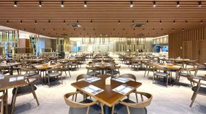 a dining room with wooden tables and chairs at Commodore Hotel Gyeongju in Gyeongju