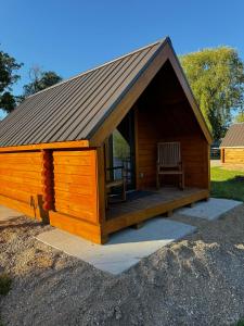 a large wooden cabin with a chair in it at Lost Trail in Lava Hot Springs