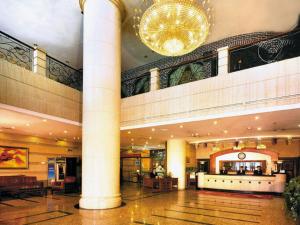 a large lobby with a chandelier in a building at Dalian Zhongshan Hotel in Dalian