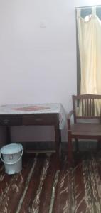 a room with a table and a chair and a desk at Sri Siva Jothi Illam in Chidambaram
