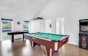 a living room with a pool table and a piano at Holiday Home Fyrvej Blåvand Iv in Blåvand