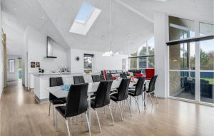 a kitchen and dining room with a table and chairs at Holiday Home Fyrvej Blåvand Iv in Blåvand