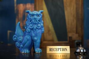 a blue cat figurine sitting on a table next to a sign at Hotel 385 in Miyako Island