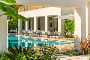 an external view of a villa with a swimming pool at Resort Miramonti in Forte dei Marmi